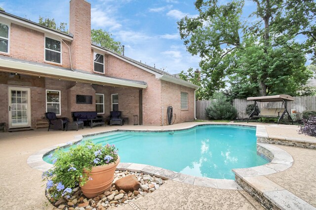 view of pool featuring outdoor lounge area and a patio