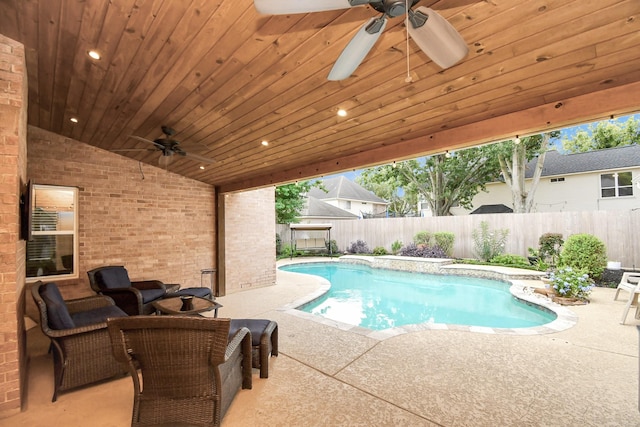 view of swimming pool with ceiling fan and a patio