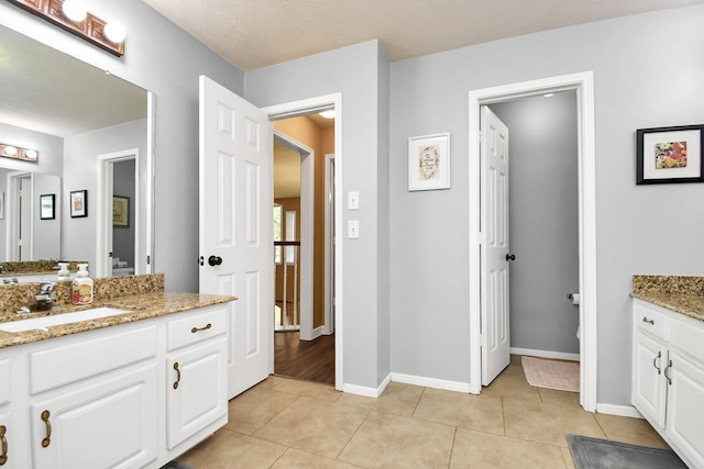 bathroom featuring tile patterned flooring and vanity