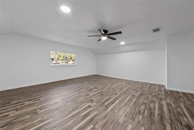 empty room with ceiling fan, lofted ceiling, and dark wood-type flooring