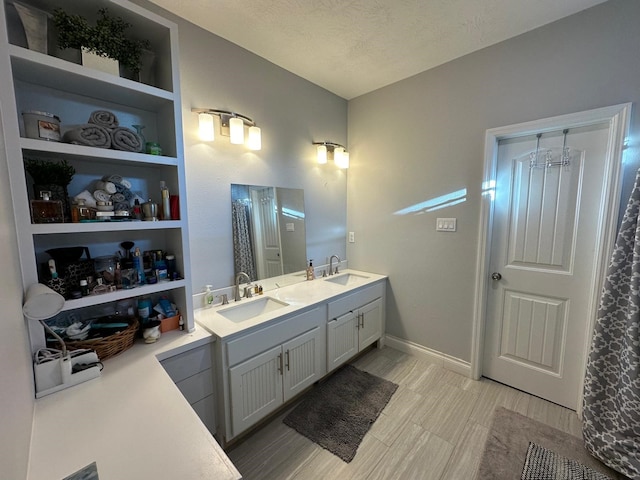 bathroom featuring vanity, a chandelier, and a textured ceiling