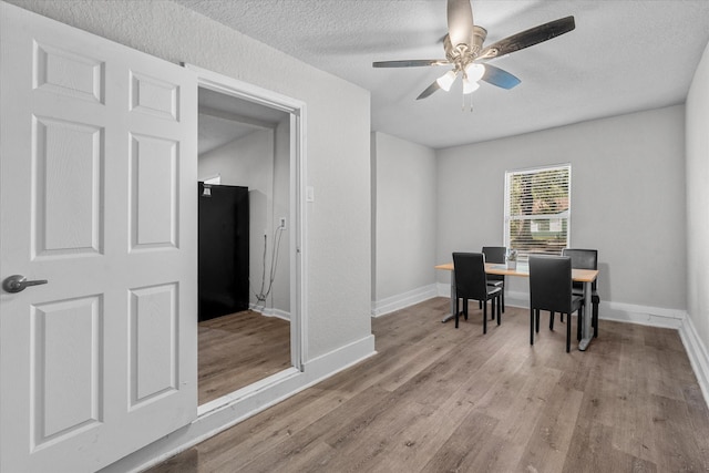 5107 Dickens Rd, Houston, TX 77021 - dining area with ceiling fan, a textured ceiling, and light hardwood / wood-style flooring