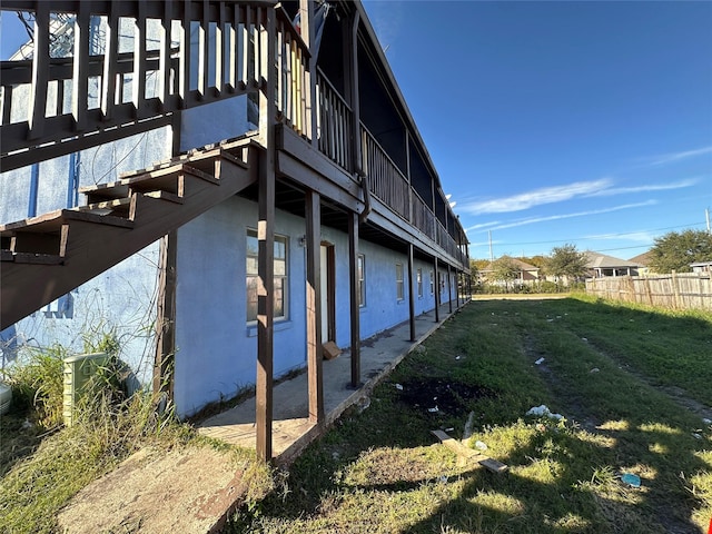 view of side of property with a lawn