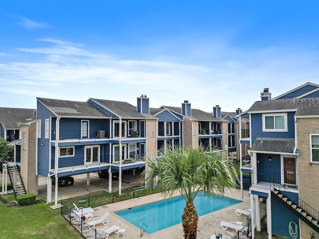 pool with a patio and a residential view