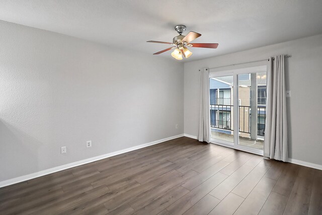 unfurnished room with ceiling fan and dark wood-type flooring