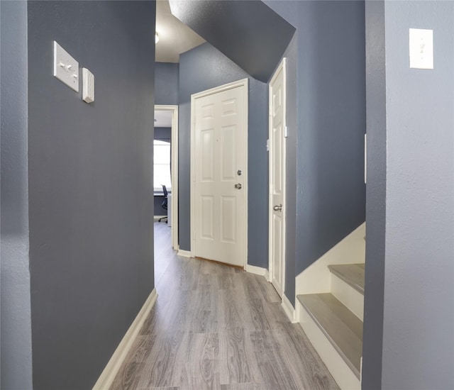 corridor with light hardwood / wood-style floors