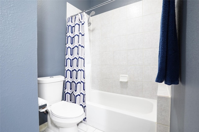 bathroom featuring shower / bath combo and toilet