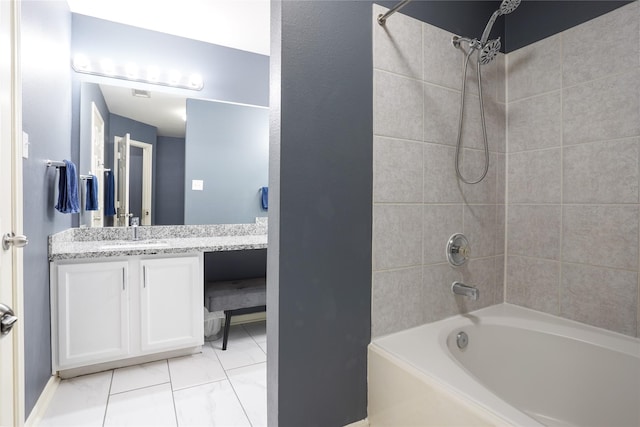 bathroom featuring vanity and tiled shower / bath