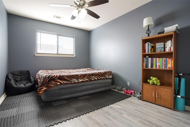 bedroom with ceiling fan and light hardwood / wood-style flooring