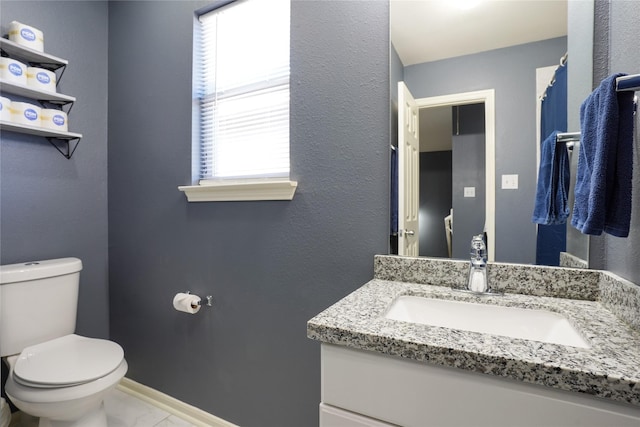 bathroom featuring vanity and toilet