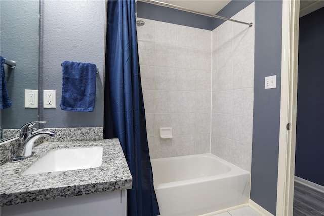 bathroom featuring shower / bath combination with curtain, vanity, and hardwood / wood-style flooring