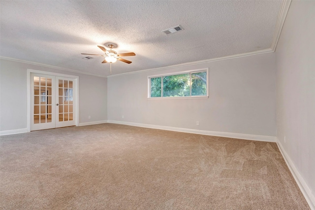 carpeted empty room featuring a textured ceiling, ceiling fan, ornamental molding, and french doors