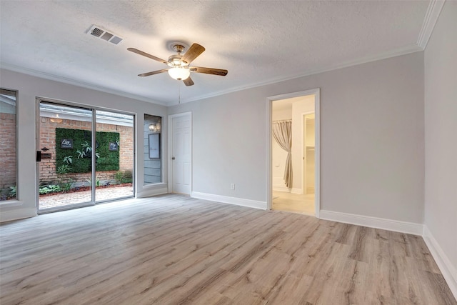 spare room featuring ceiling fan, a textured ceiling, ornamental molding, and light hardwood / wood-style flooring