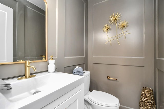 bathroom featuring toilet and vanity