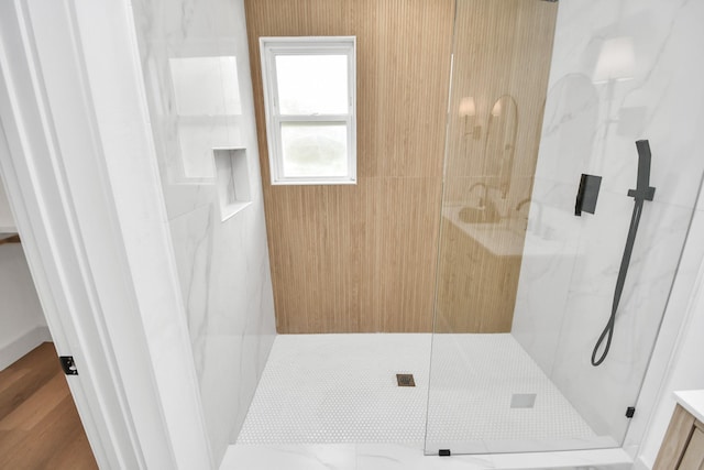 bathroom featuring a shower with door