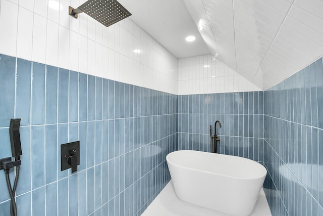 bathroom with sink, tile walls, a bathtub, and tile patterned flooring