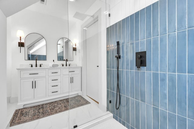 bathroom featuring a shower and vanity