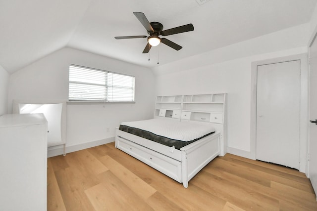 unfurnished bedroom with light wood-type flooring, ceiling fan, and lofted ceiling