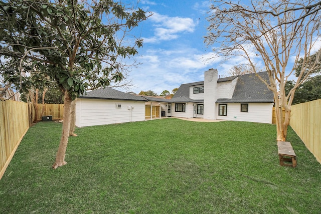 back of house featuring a lawn and a patio