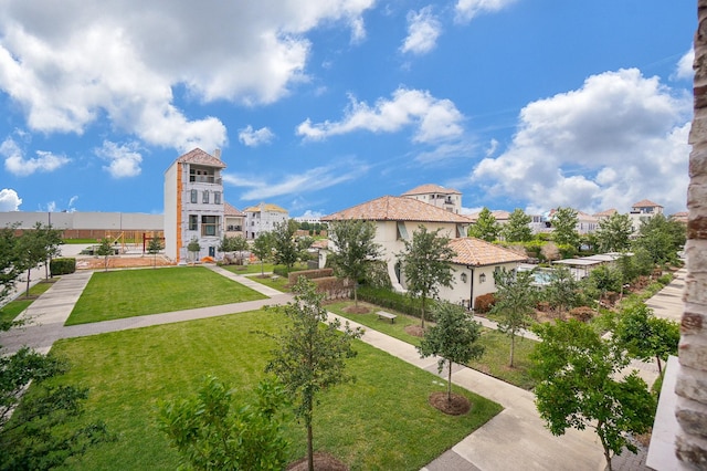 view of property's community featuring a lawn