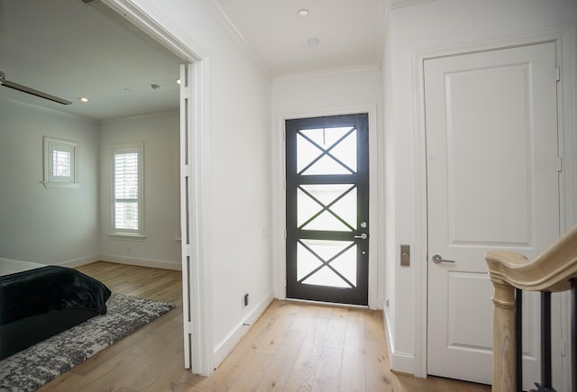 entryway featuring light hardwood / wood-style floors and crown molding