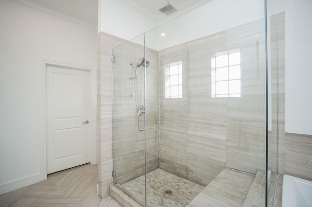 bathroom with a shower with door, parquet floors, and ornamental molding