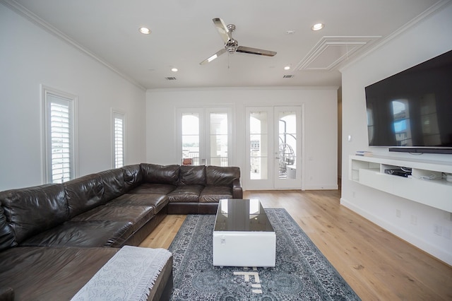 unfurnished living room with wood-type flooring, a wealth of natural light, ornamental molding, and ceiling fan