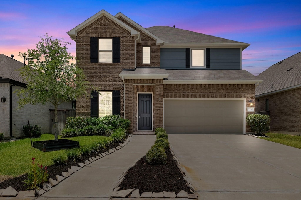 view of front facade with a yard and a garage