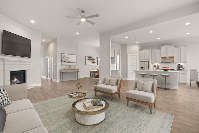 23319 Persimmon Creek Ln, Katy, TX 77493 - living room with recessed lighting, light wood-type flooring, a ceiling fan, and a glass covered fireplace