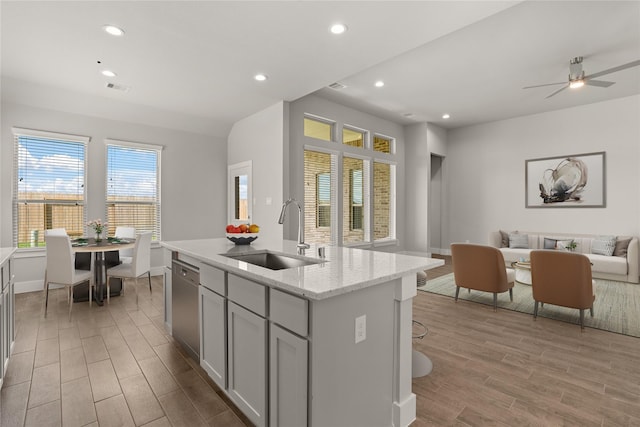 23319 Persimmon Creek Ln, Katy, TX 77493 - kitchen with open floor plan, light wood finished floors, dishwasher, gray cabinetry, and recessed lighting