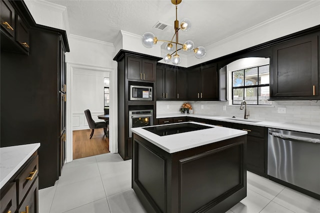 kitchen featuring sink, backsplash, decorative light fixtures, light tile patterned flooring, and appliances with stainless steel finishes