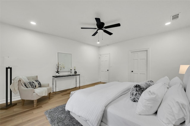 bedroom with light hardwood / wood-style flooring and ceiling fan