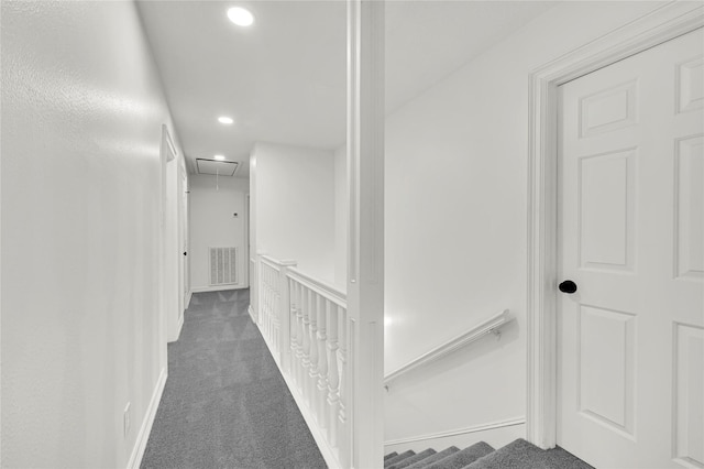 hallway with dark colored carpet