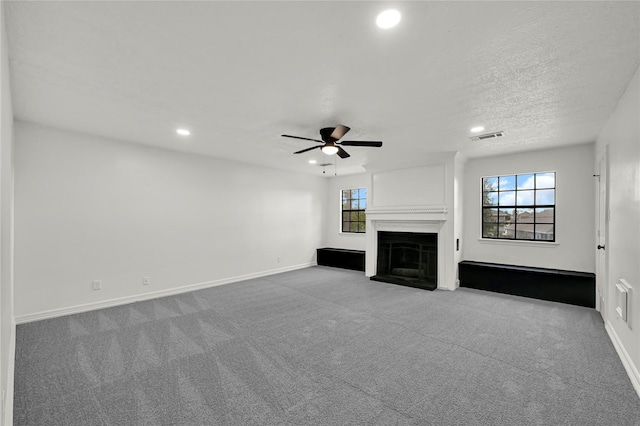 unfurnished living room featuring ceiling fan and light colored carpet