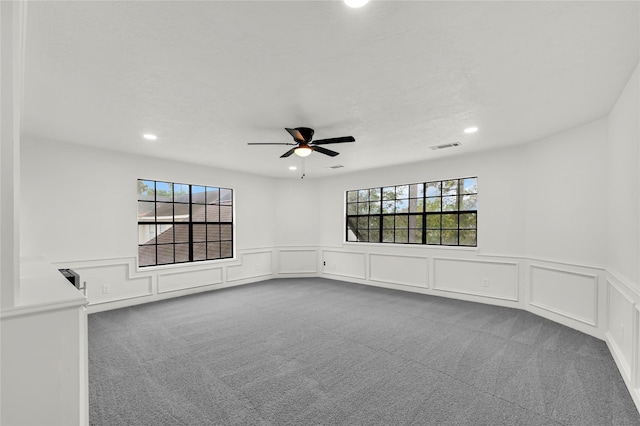 carpeted spare room with ceiling fan