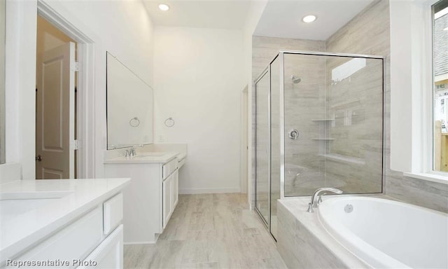 bathroom with vanity and separate shower and tub