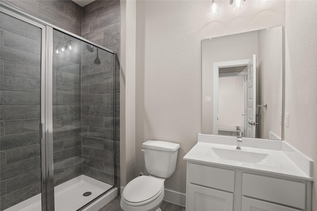 bathroom featuring vanity, toilet, and walk in shower