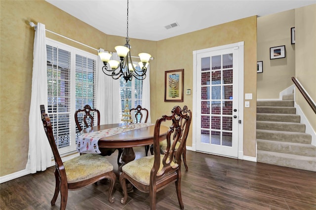 dining room featuring dark hardwood / wood-style flooring and an inviting chandelier