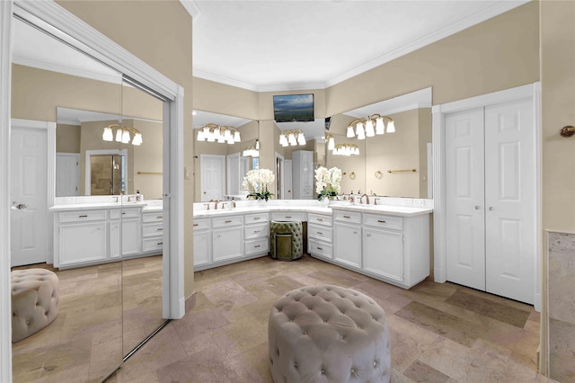 bathroom with vanity, a chandelier, and ornamental molding