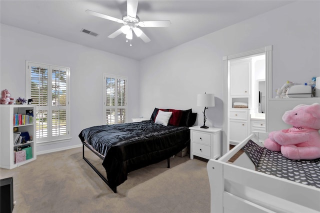 carpeted bedroom featuring ceiling fan and ensuite bathroom