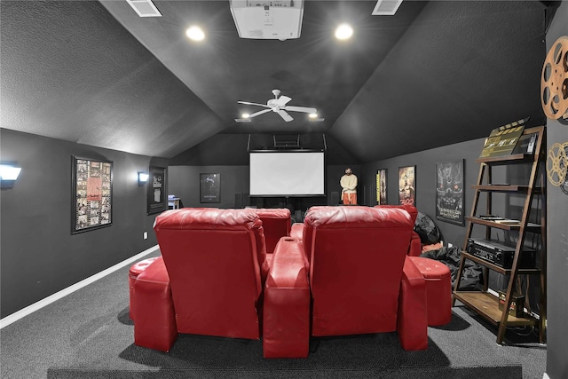 carpeted home theater room with ceiling fan and vaulted ceiling