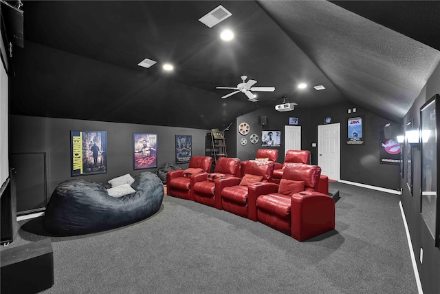 carpeted cinema room featuring a textured ceiling, ceiling fan, and vaulted ceiling