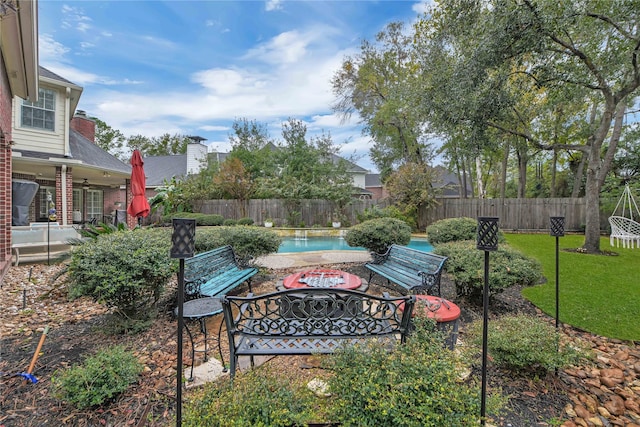 view of yard featuring a fenced in pool and ceiling fan