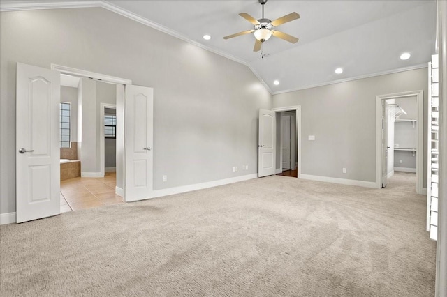 carpeted spare room featuring high vaulted ceiling, ceiling fan, and ornamental molding