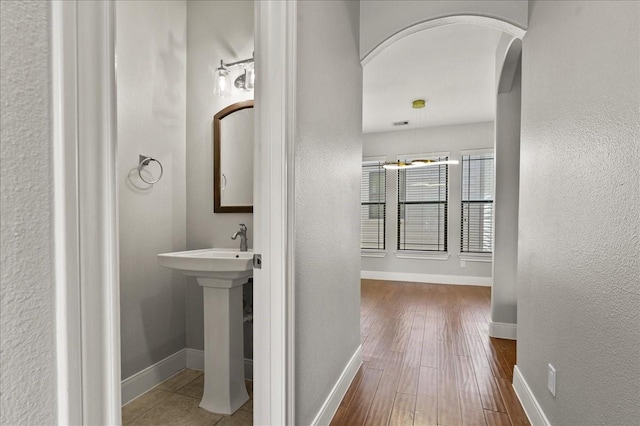 bathroom with wood-type flooring and sink