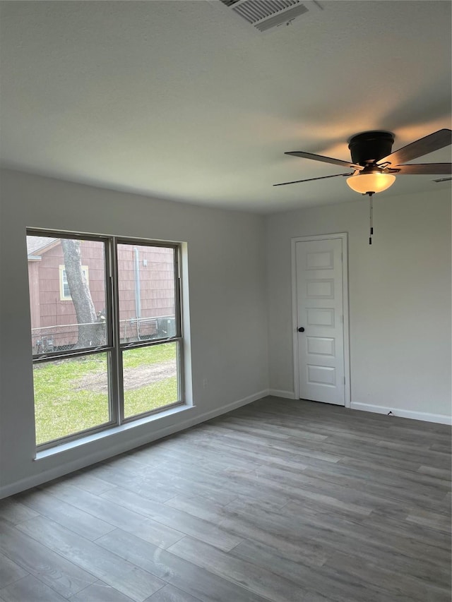 empty room featuring hardwood / wood-style flooring and ceiling fan