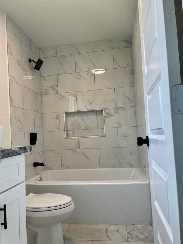 full bathroom with tiled shower / bath, vanity, and toilet