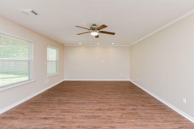 spare room with wood-type flooring, ceiling fan, and crown molding