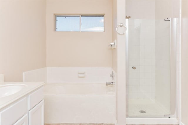 bathroom featuring vanity and independent shower and bath