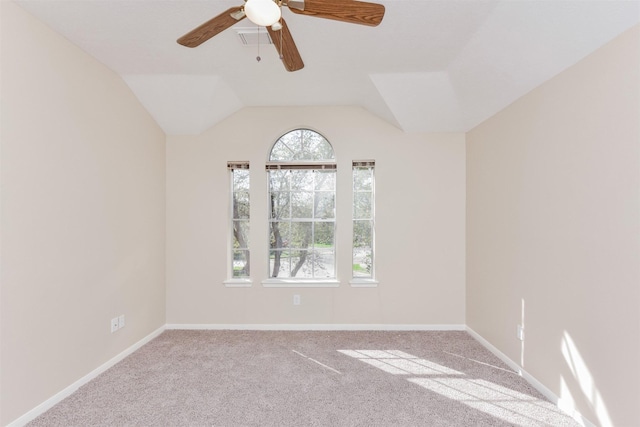 carpeted spare room featuring ceiling fan and lofted ceiling